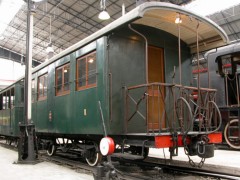 Ein grüner Stadtbahn–Wagen, offene Plattformen, im Technikmuseum in Mailand.