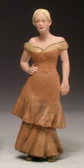 Die Figur einer jungen Frau mit einem schulterfreien, unten gefälteten Kleid.