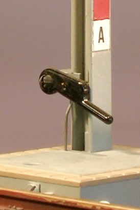Modellfoto: der Stellhebel am unteren Mastende eines Spielsignals mit einem zusätzlichen Stelldraht.